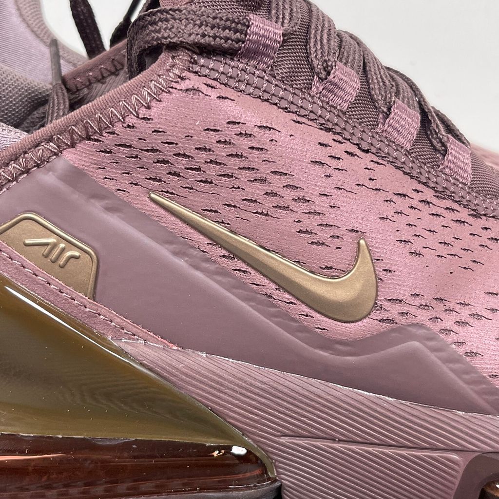 Side profile of the Nike Air Max 270 Premium 'Tattoo' in Metallic Red Bronze, showcasing the shimmering metallic upper, detailed tattoo-inspired graphic overlays, and the massive translucent Max Air unit.