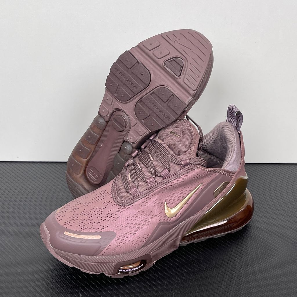 Side profile of the Nike Air Max 270 Premium 'Tattoo' in Metallic Red Bronze, showcasing the shimmering metallic upper, detailed tattoo-inspired graphic overlays, and the massive translucent Max Air unit.