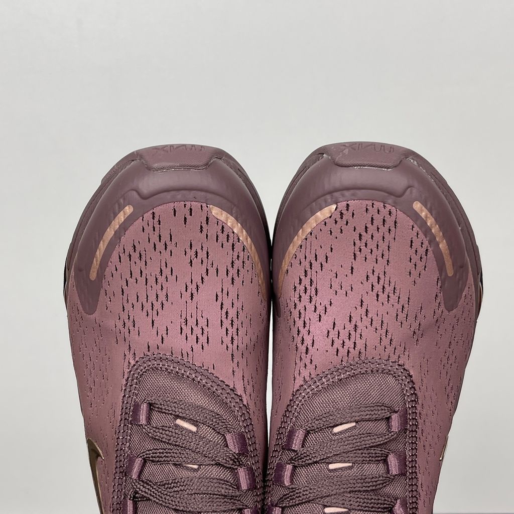Side profile of the Nike Air Max 270 Premium 'Tattoo' in Metallic Red Bronze, showcasing the shimmering metallic upper, detailed tattoo-inspired graphic overlays, and the massive translucent Max Air unit.