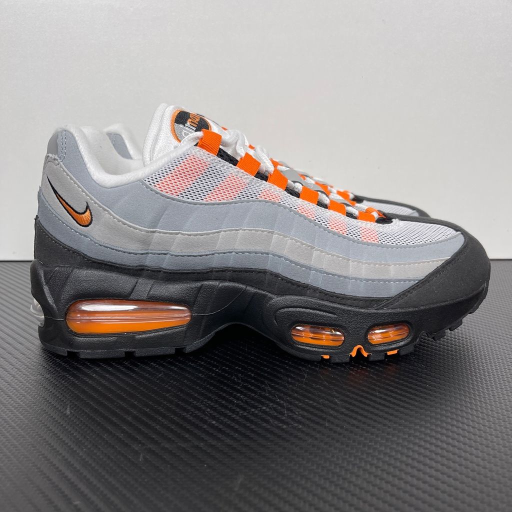 Side profile of the Nike Air Max 95 OG 'Big Bubble' Bright Mandarin 2.0, showcasing the signature layered gradient upper, vibrant orange eyelets and branding, and the enlarged visible Air unit in the heel.