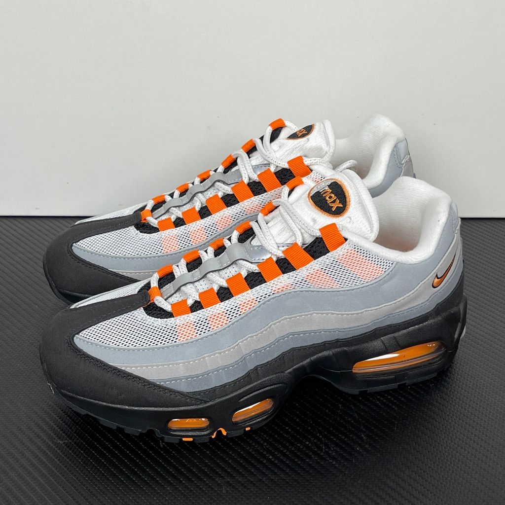 Side profile of the Nike Air Max 95 OG 'Big Bubble' Bright Mandarin 2.0, showcasing the signature layered gradient upper, vibrant orange eyelets and branding, and the enlarged visible Air unit in the heel.