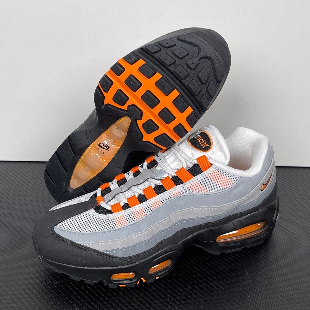 Side profile of the Nike Air Max 95 OG 'Big Bubble' Bright Mandarin 2.0, showcasing the signature layered gradient upper, vibrant orange eyelets and branding, and the enlarged visible Air unit in the heel.