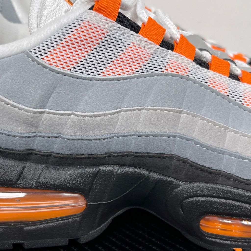 Side profile of the Nike Air Max 95 OG 'Big Bubble' Bright Mandarin 2.0, showcasing the signature layered gradient upper, vibrant orange eyelets and branding, and the enlarged visible Air unit in the heel.