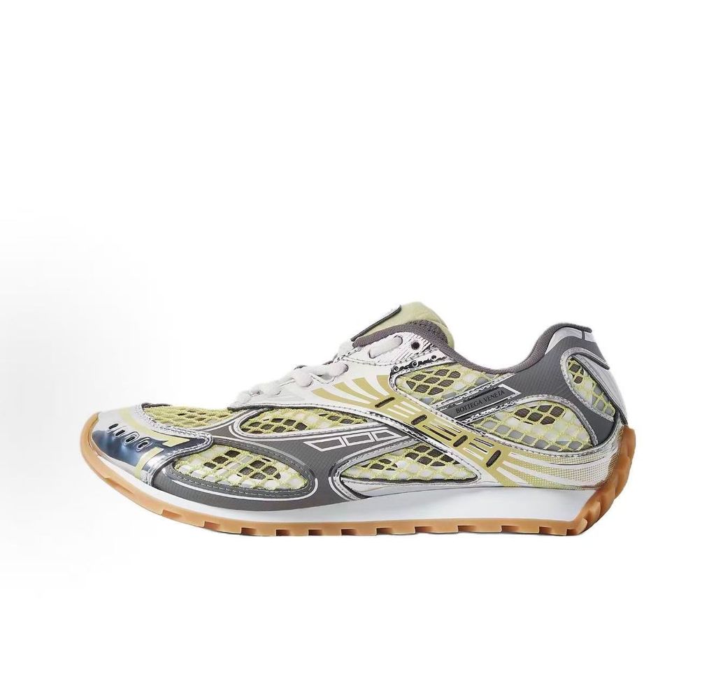 Side profile of the Bottega Veneta Orbit Runner sneaker, showcasing its intricate metallic and green-yellow technical mesh construction, prominent "BOTTEGA VENETA" branding, and the textured gum-tone outsole.