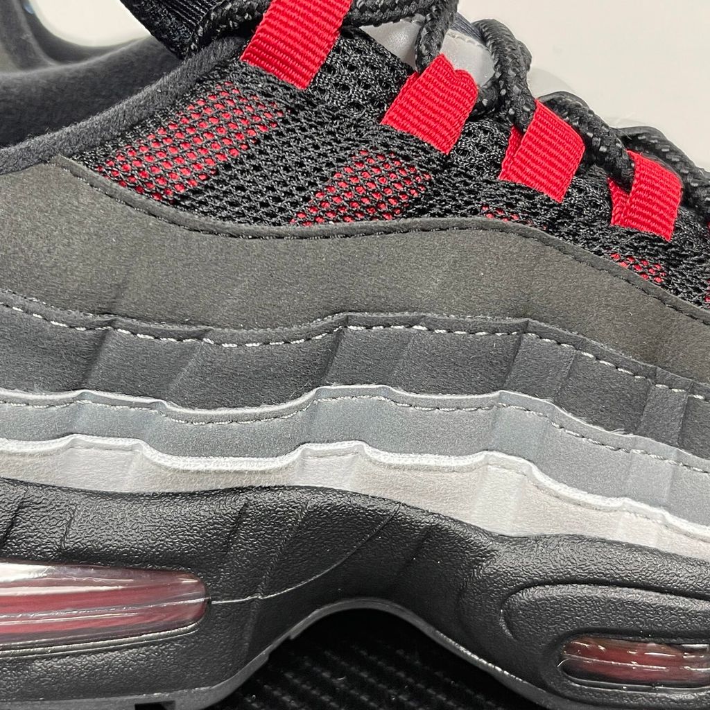 Side profile of the Nike Air Max 95 OG 'Big Bubble' x Liverpool F.C., showcasing the signature anatomy-inspired gradient upper, subtle club-inspired color accents, and the enlarged visible Air unit in the heel.