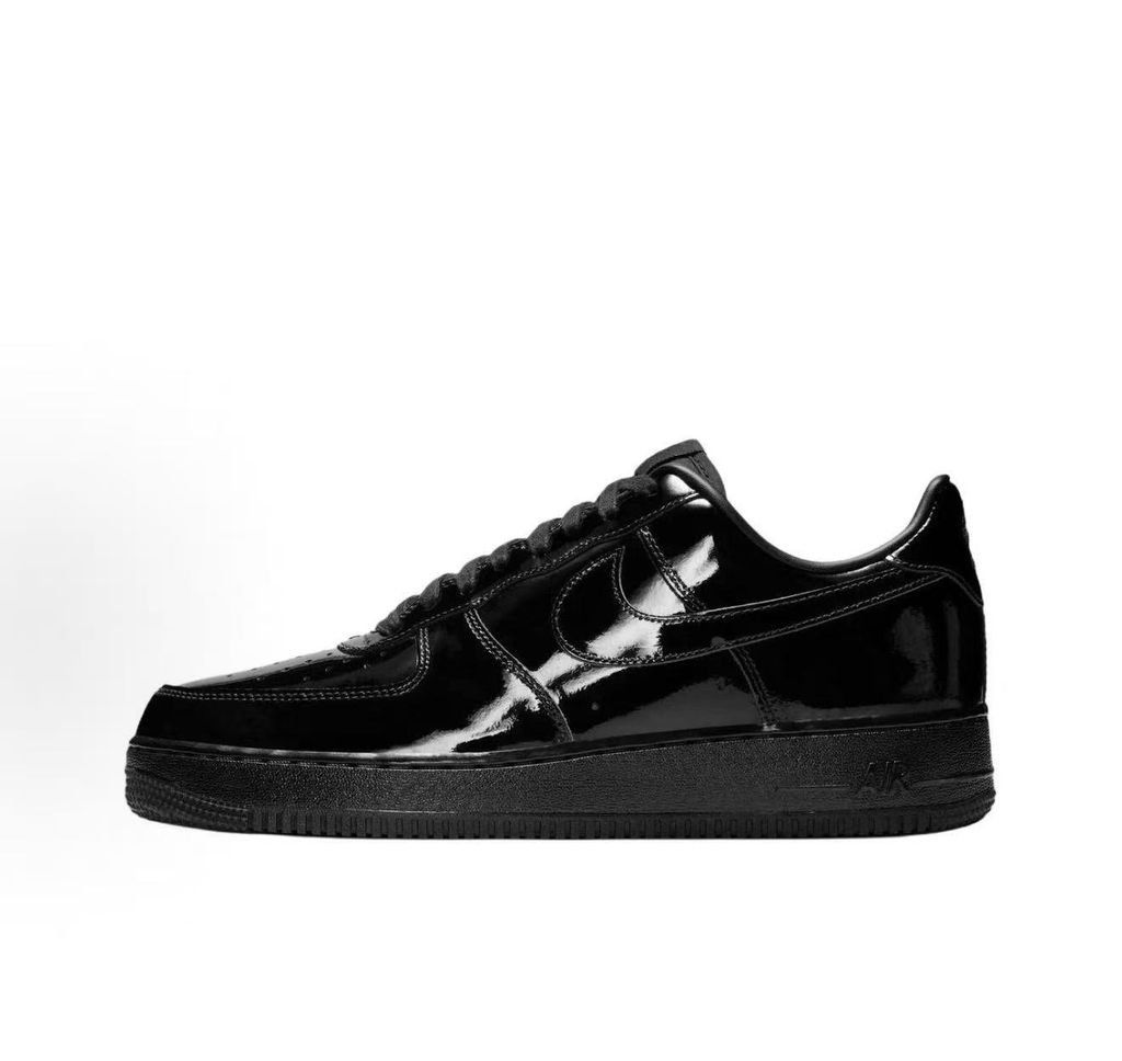 Side profile of the Nike Air Force 1 Low '07 Premium 'Black Patent', showcasing the high-gloss all-black patent leather upper, tonal Swoosh, and classic black rubber midsole.