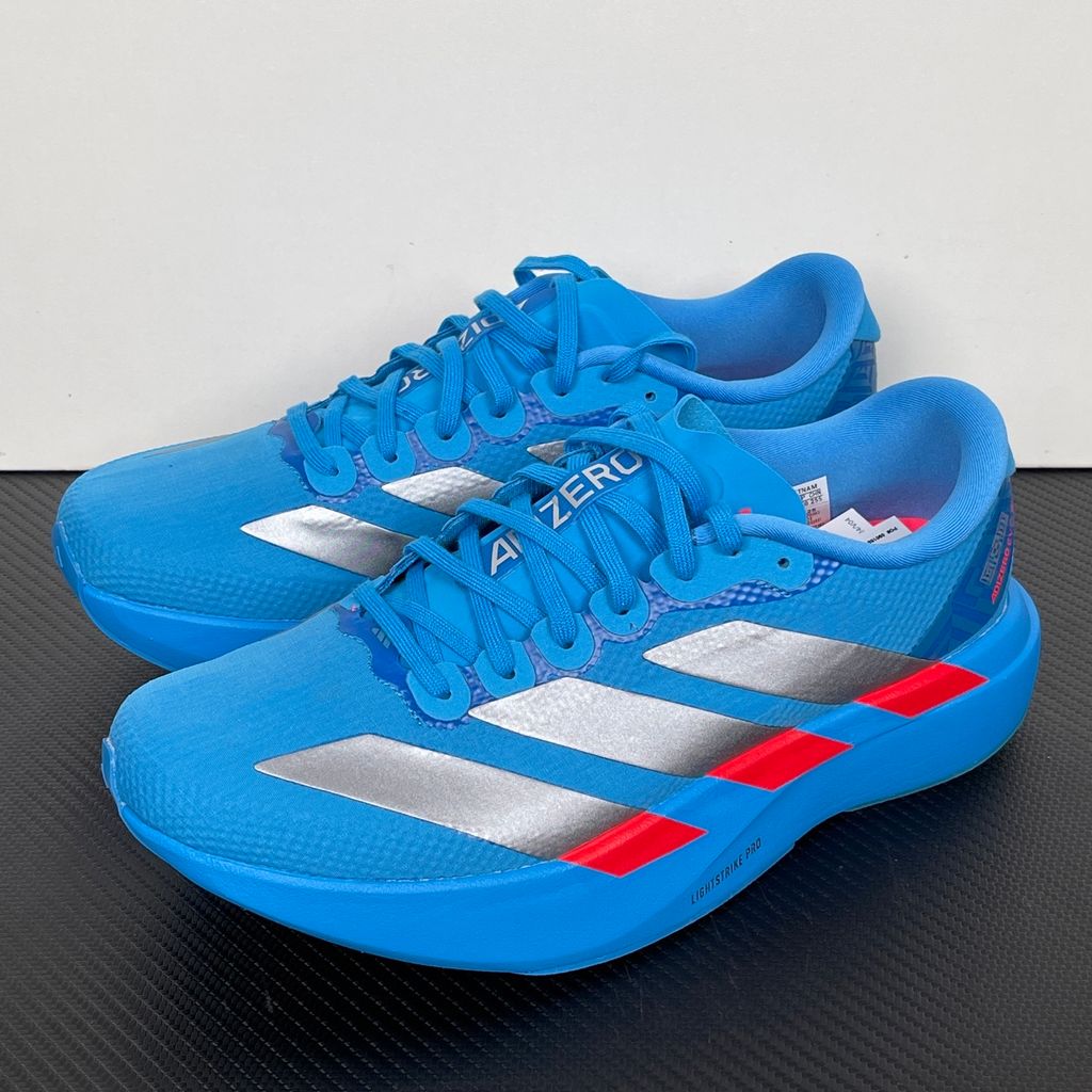 Side profile of the adidas Adizero Evo SL 'Ekiden' in a vibrant Solar Blue colorway, showcasing the breathable mesh upper, prominent Silver Metallic 3-Stripes branding, and the responsive Lightstrike Pro cushioned midsole.