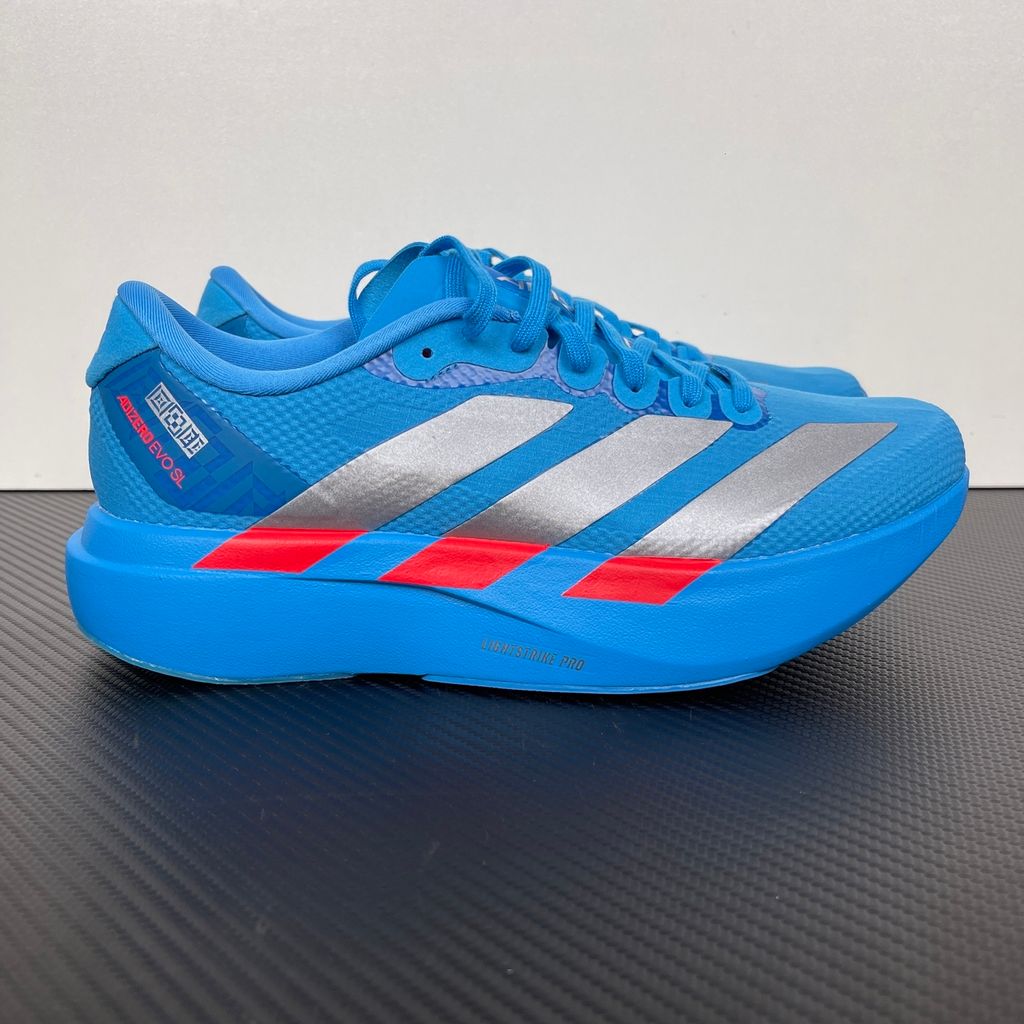 Side profile of the adidas Adizero Evo SL 'Ekiden' in a vibrant Solar Blue colorway, showcasing the breathable mesh upper, prominent Silver Metallic 3-Stripes branding, and the responsive Lightstrike Pro cushioned midsole.