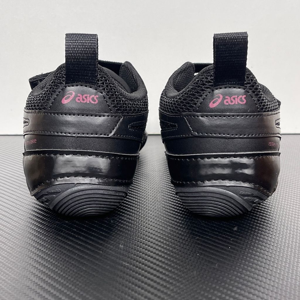 Side profile of the ASICS Hyper Taping x Issey Miyake in all-black, showcasing the sleek minimalist upper, intricate structural tape overlays, and streamlined black midsole.