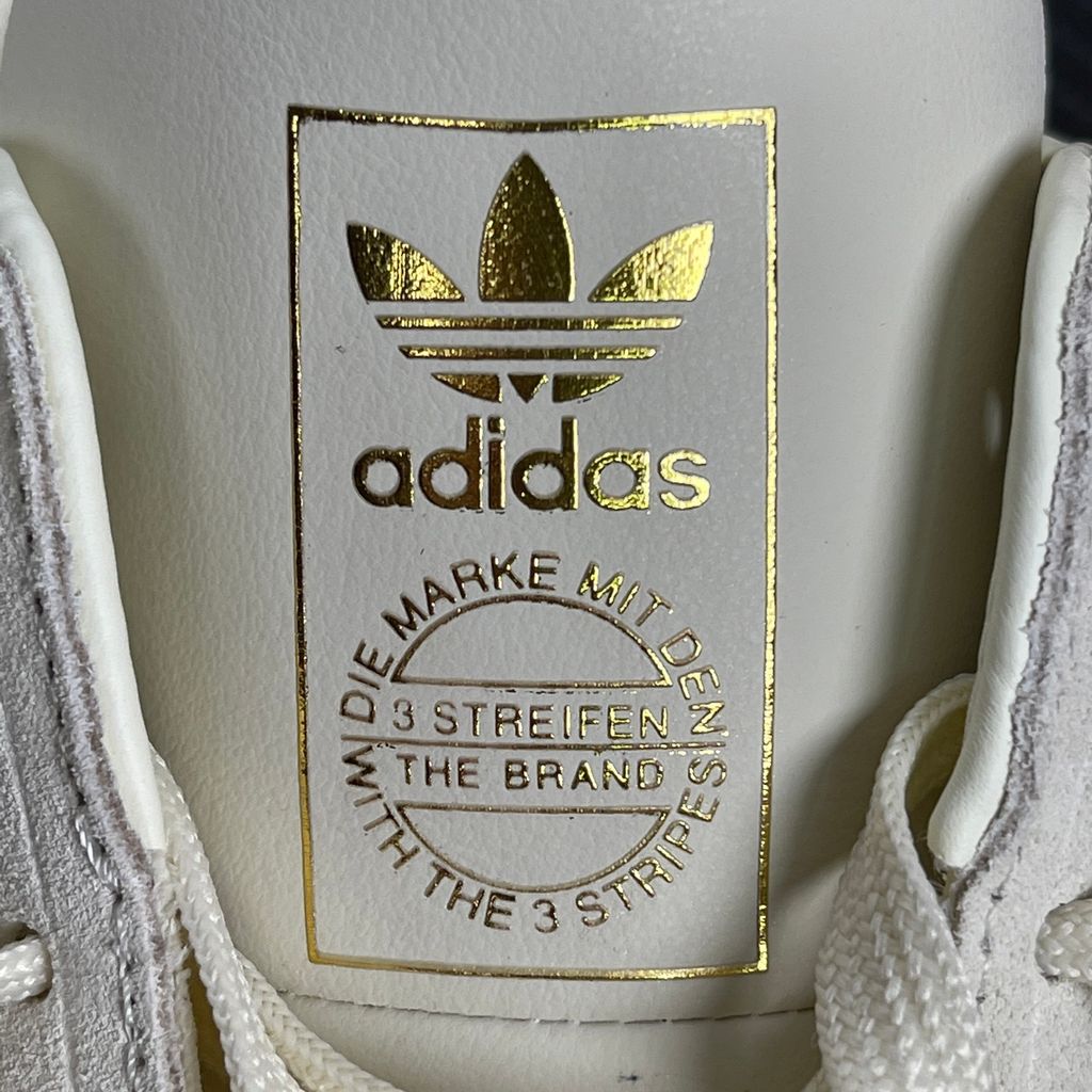 Side profile of the adidas Samba OG Mule W in Cream White, showcasing the backless slip-on silhouette, intricate woven side panels replacing the traditional 3-Stripes, premium suede T-toe, and light gum rubber outsole.