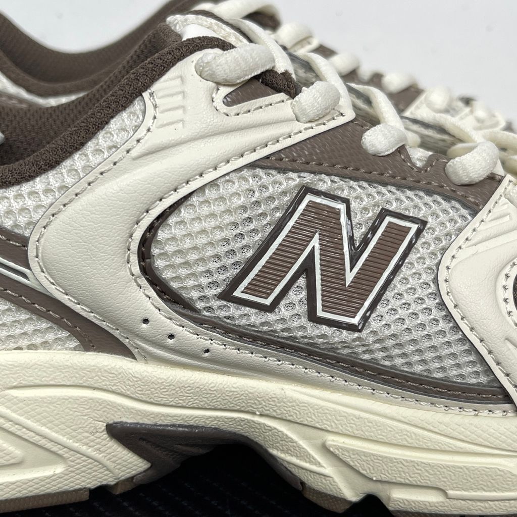 Side profile of the New Balance 530 'Turtledove Mushroom', showcasing the breathable cream mesh upper, earthy mushroom brown synthetic overlays, classic 'N' logo, and the chunky ABZORB cushioned midsole.