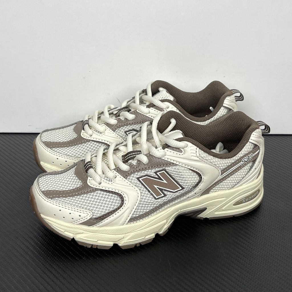 Side profile of the New Balance 530 'Turtledove Mushroom', showcasing the breathable cream mesh upper, earthy mushroom brown synthetic overlays, classic 'N' logo, and the chunky ABZORB cushioned midsole.