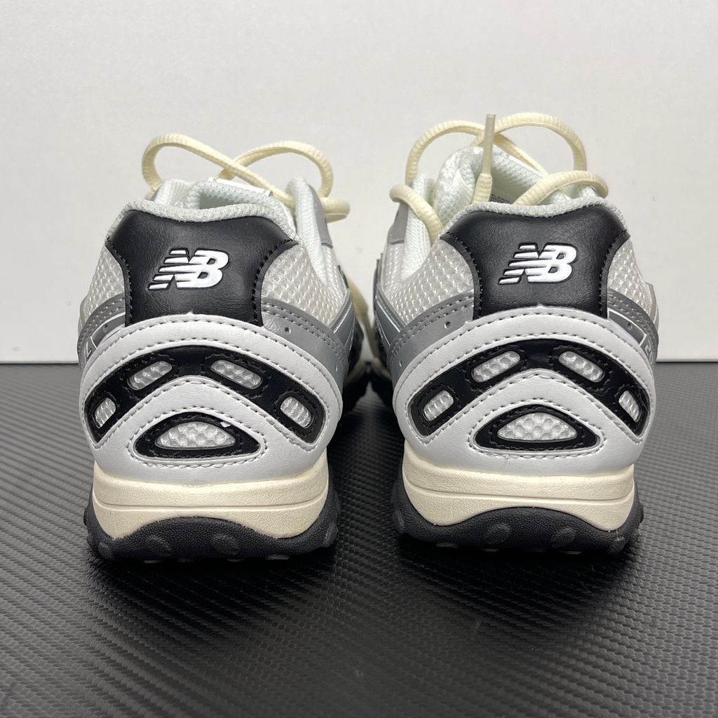 Side profile of the New Balance 204L 'Silver Metallic Black', showcasing the breathable black mesh upper, dynamic silver metallic synthetic overlays, classic 'N' logo, and a sleek, cushioned runner midsole.