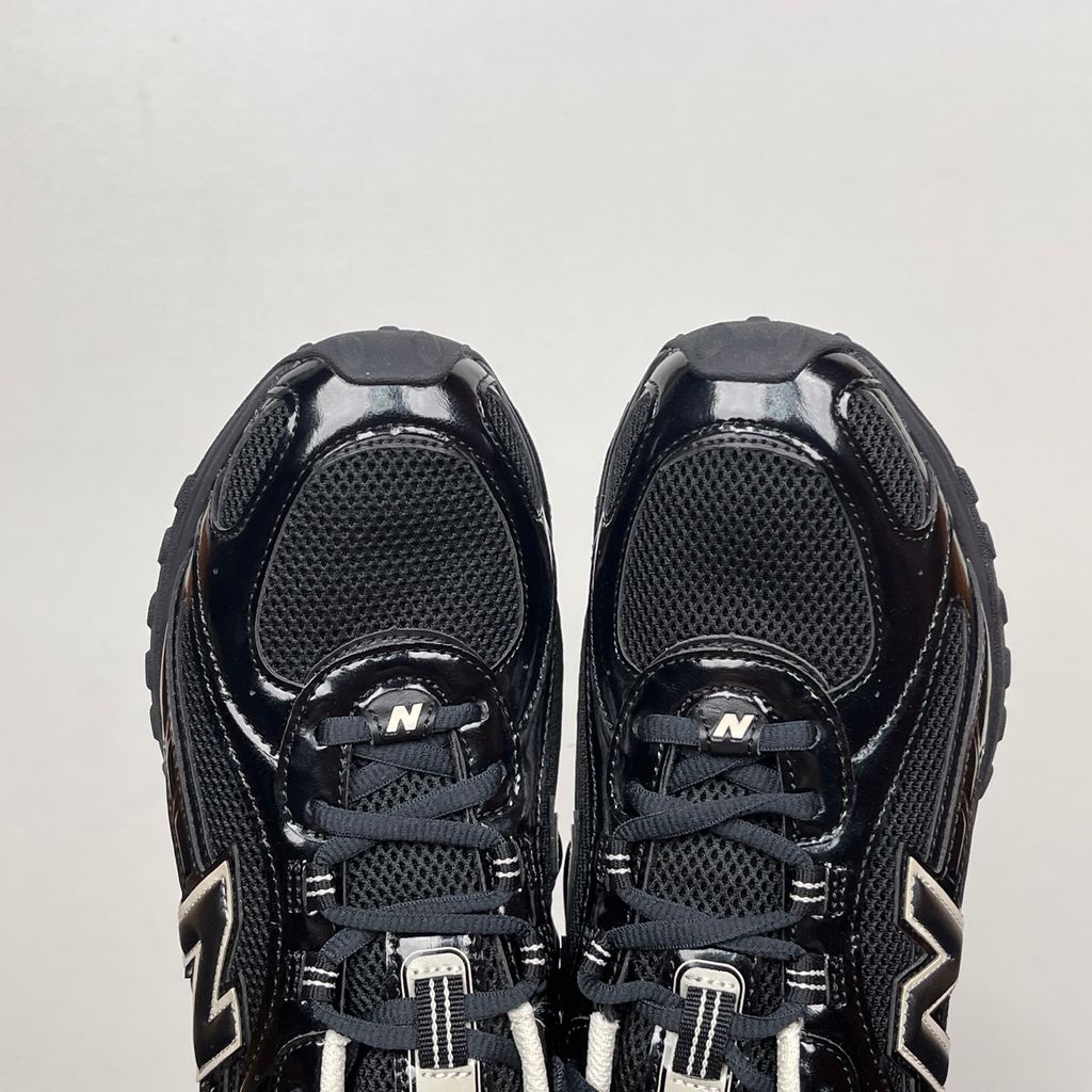 Side profile of the New Balance 204L 'Black Timberwolf', showcasing the breathable black mesh upper, dynamic taupe-grey Timberwolf synthetic overlays, classic 'N' logo, and a sleek, cushioned runner midsole.