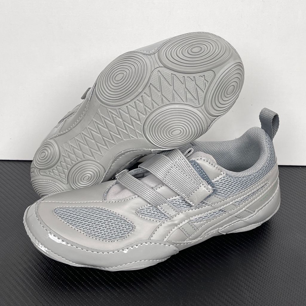 Side profile of the ASICS Hyper Taping x Issey Miyake in a monochromatic grey colorway, showcasing the sleek minimalist upper, intricate structural tape overlays, and streamlined tonal midsole.