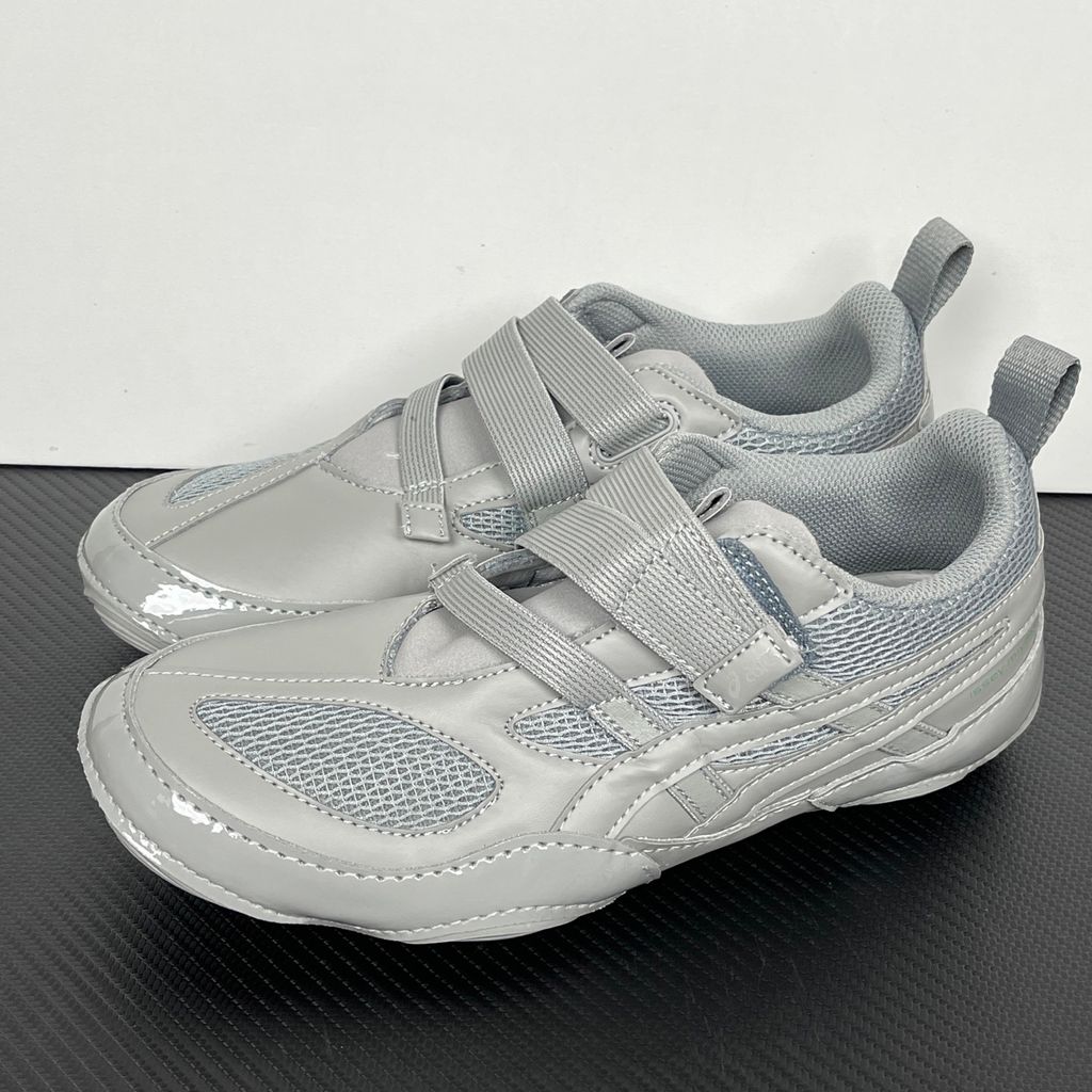 Side profile of the ASICS Hyper Taping x Issey Miyake in a monochromatic grey colorway, showcasing the sleek minimalist upper, intricate structural tape overlays, and streamlined tonal midsole.