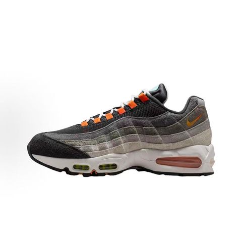 Side profiles of the left and right Nike Air Max 95 OG 'Big Bubble' Greedy (2026) sneakers, showcasing the asymmetrical, mismatched multi-color gradient uppers and the exaggerated visible Air units in the black midsole.