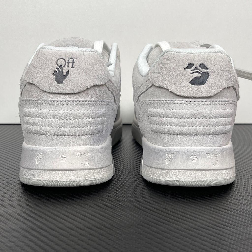 Side profile of the Off-White Out Of Office sneaker in Light Grey, showcasing the tonal distressed suede upper, signature Arrow logo, leather tag detail on the laces, and a white midsole featuring translucent gel inserts.