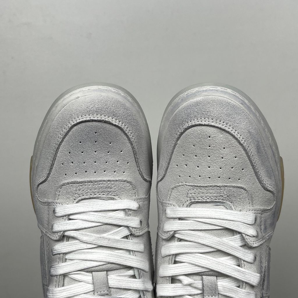 Side profile of the Off-White Out Of Office sneaker in Light Grey, showcasing the tonal distressed suede upper, signature Arrow logo, leather tag detail on the laces, and a white midsole featuring translucent gel inserts.