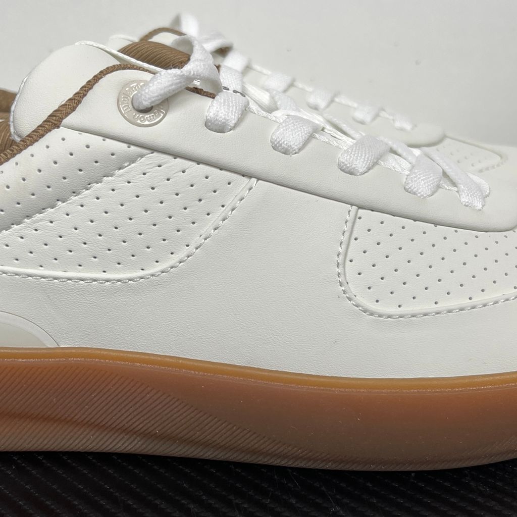 Side profile of the lululemon Cityverse Perforated Sneaker, showcasing the clean white leather upper with custom perforation patterns, a supportive gum rubber midsole, and a faux-fur leopard print heel tab.
