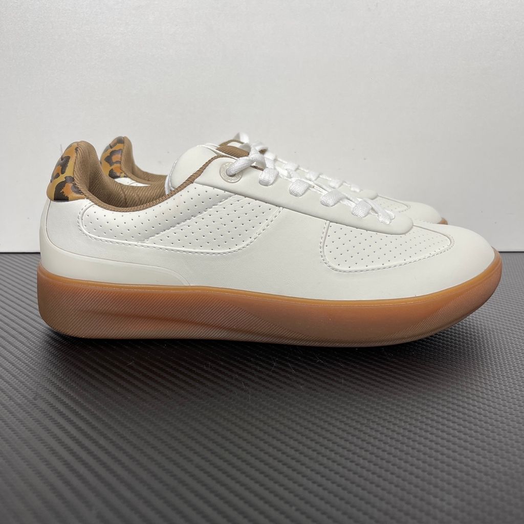 Side profile of the lululemon Cityverse Perforated Sneaker, showcasing the clean white leather upper with custom perforation patterns, a supportive gum rubber midsole, and a faux-fur leopard print heel tab.