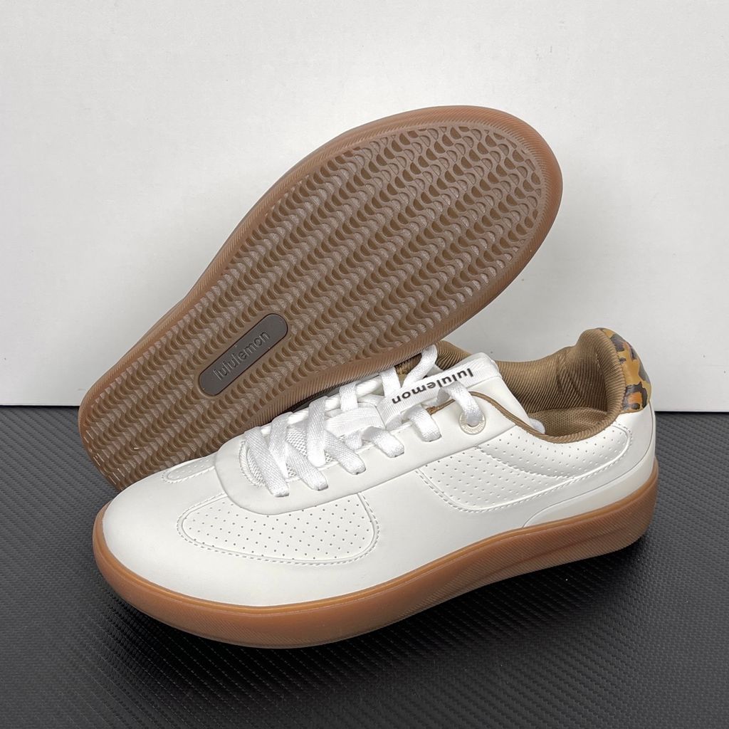 Side profile of the lululemon Cityverse Perforated Sneaker, showcasing the clean white leather upper with custom perforation patterns, a supportive gum rubber midsole, and a faux-fur leopard print heel tab.