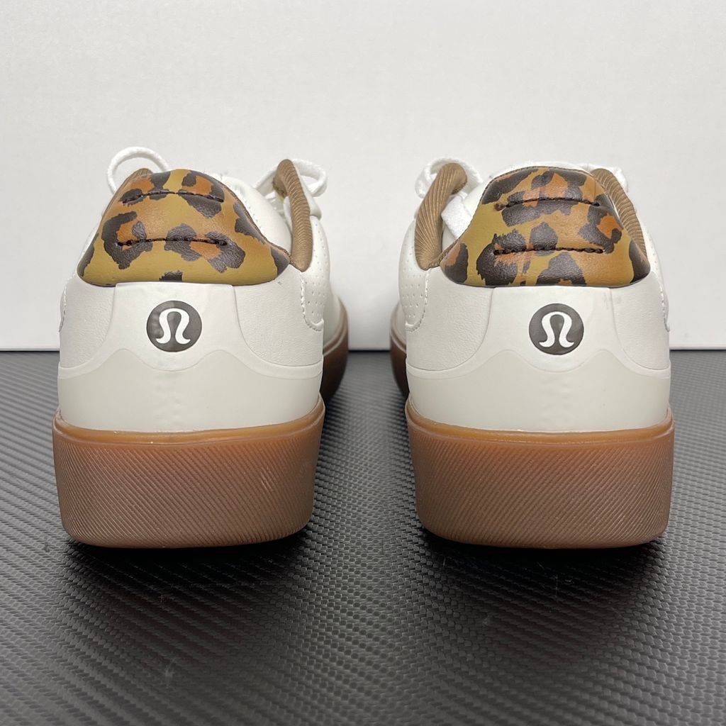 Side profile of the lululemon Cityverse Perforated Sneaker, showcasing the clean white leather upper with custom perforation patterns, a supportive gum rubber midsole, and a faux-fur leopard print heel tab.