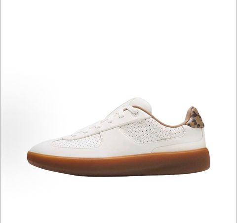 Side profile of the lululemon Cityverse Perforated Sneaker, showcasing the clean white leather upper with custom perforation patterns, a supportive gum rubber midsole, and a faux-fur leopard print heel tab.
