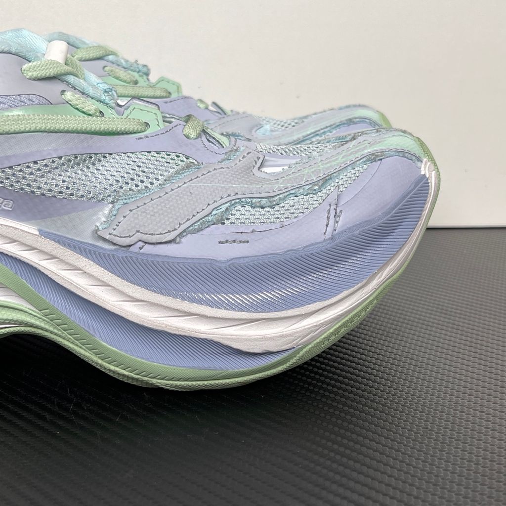 Side profile of the Balenciaga Jet Sneaker, showcasing the pastel light blue, lilac, and mint green layered mesh upper with heavy distressing and frayed edges, seated on a massively chunky, aerodynamic rocker-shaped midsole.