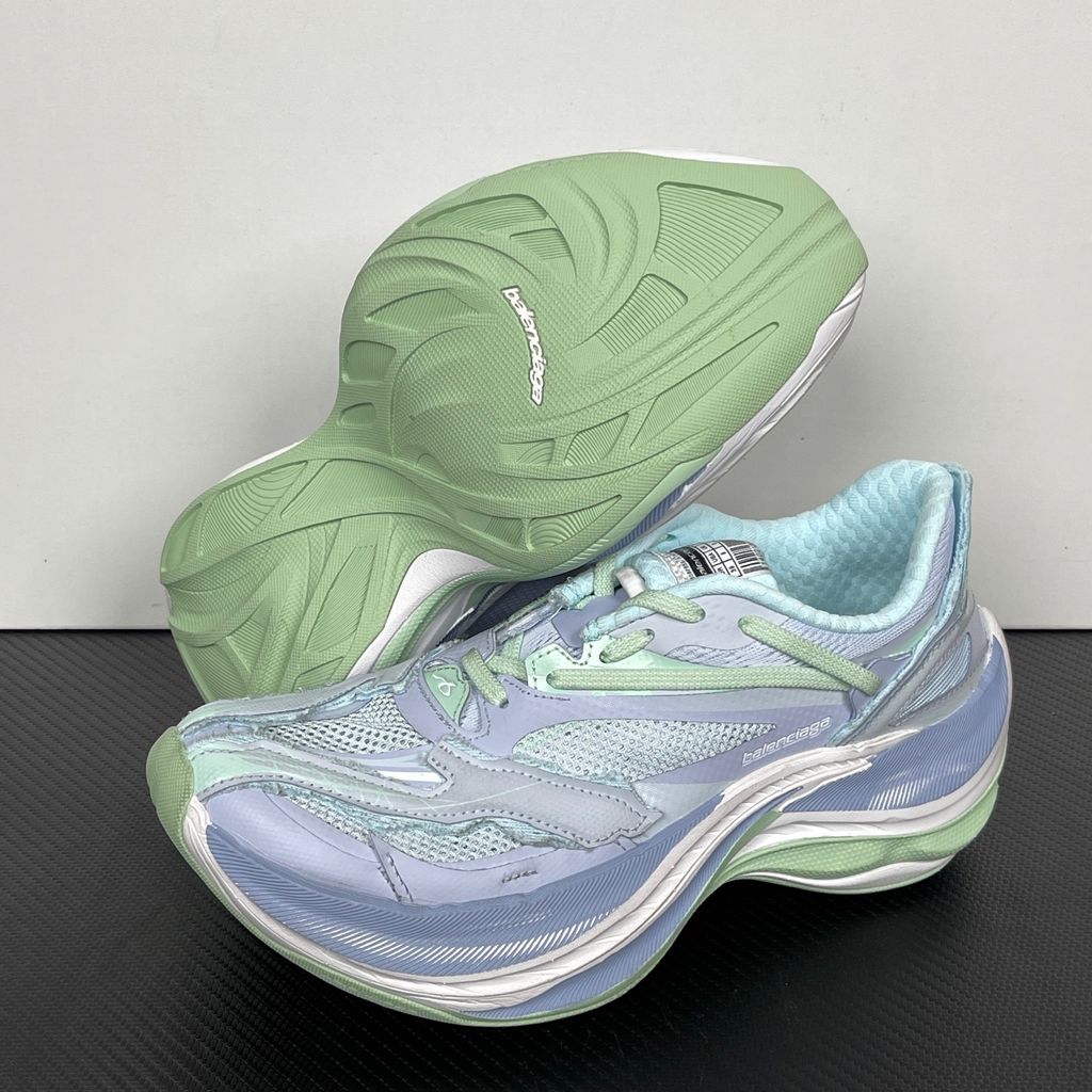 Side profile of the Balenciaga Jet Sneaker, showcasing the pastel light blue, lilac, and mint green layered mesh upper with heavy distressing and frayed edges, seated on a massively chunky, aerodynamic rocker-shaped midsole.