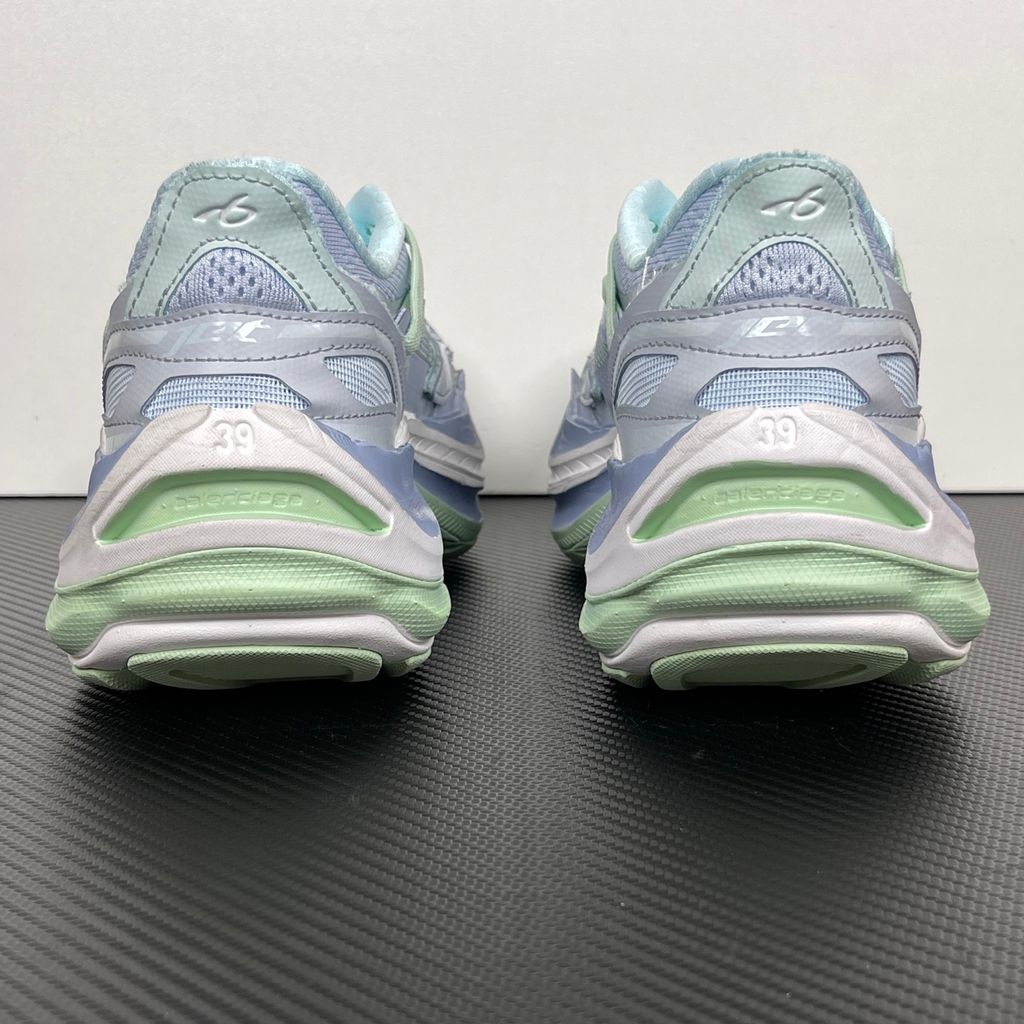 Side profile of the Balenciaga Jet Sneaker, showcasing the pastel light blue, lilac, and mint green layered mesh upper with heavy distressing and frayed edges, seated on a massively chunky, aerodynamic rocker-shaped midsole.