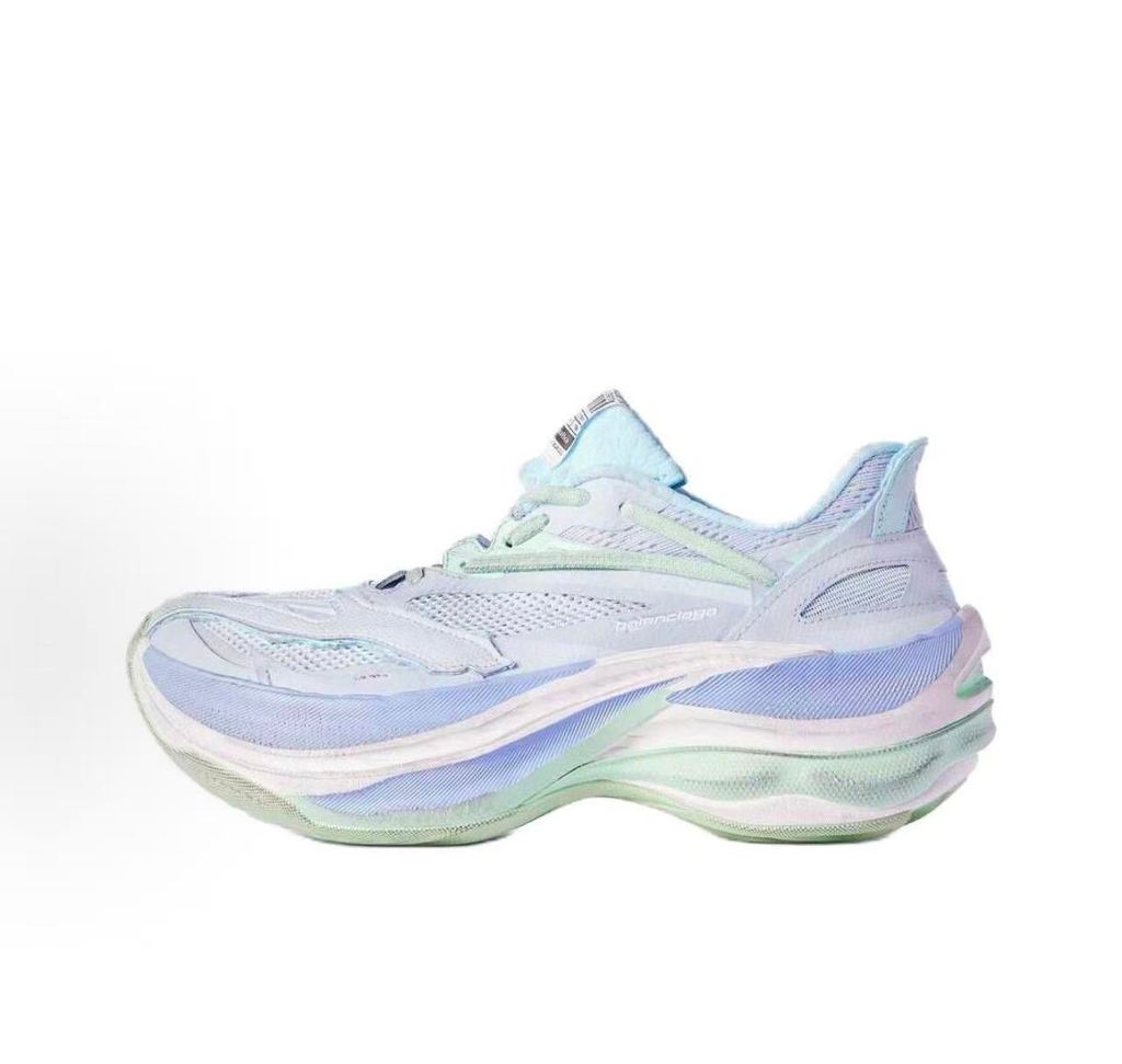 Side profile of the Balenciaga Jet Sneaker, showcasing the pastel light blue, lilac, and mint green layered mesh upper with heavy distressing and frayed edges, seated on a massively chunky, aerodynamic rocker-shaped midsole.
