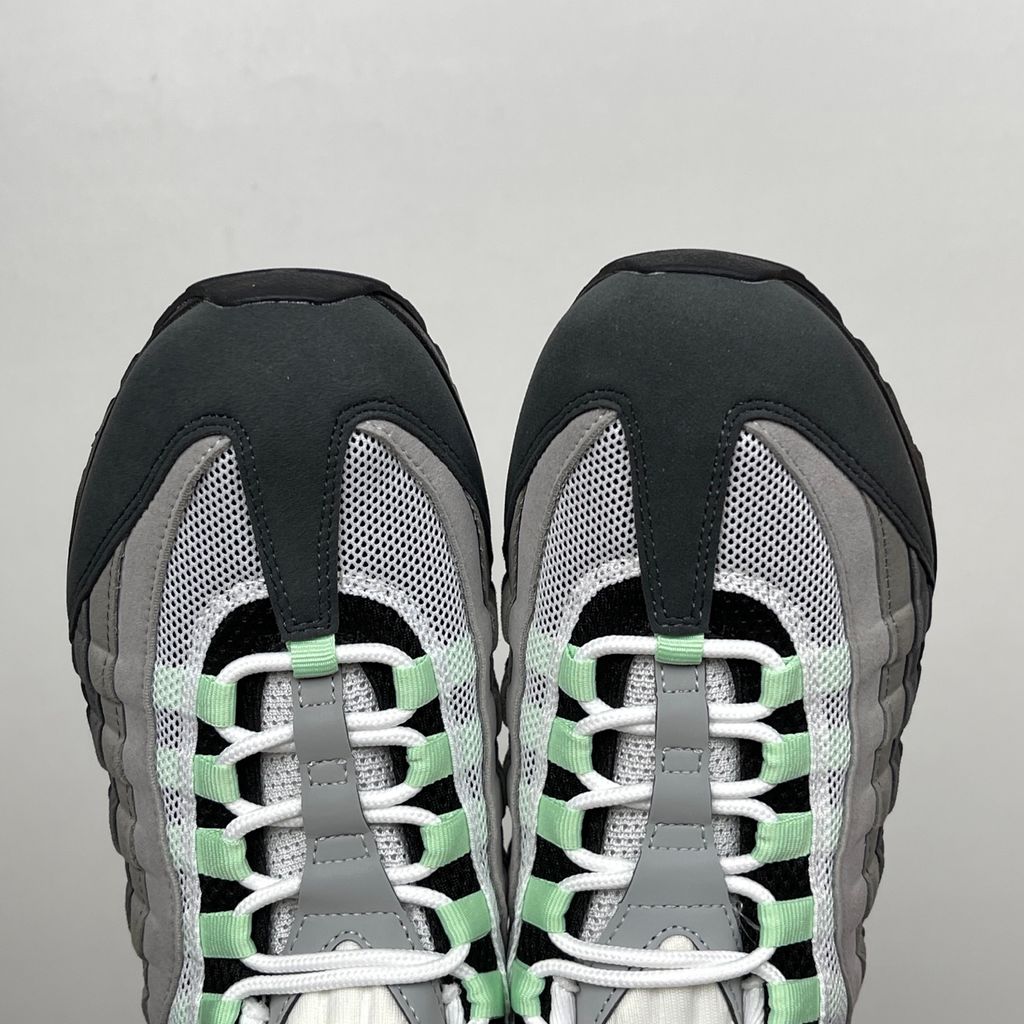 Side profile of the women's Nike Air Max 95 OG 'Big Bubble' Fresh Mint, showcasing the classic grey gradient anatomy-inspired upper, vibrant mint green lace loops and Swoosh, and the exaggerated visible Air units housed within a black midsole.