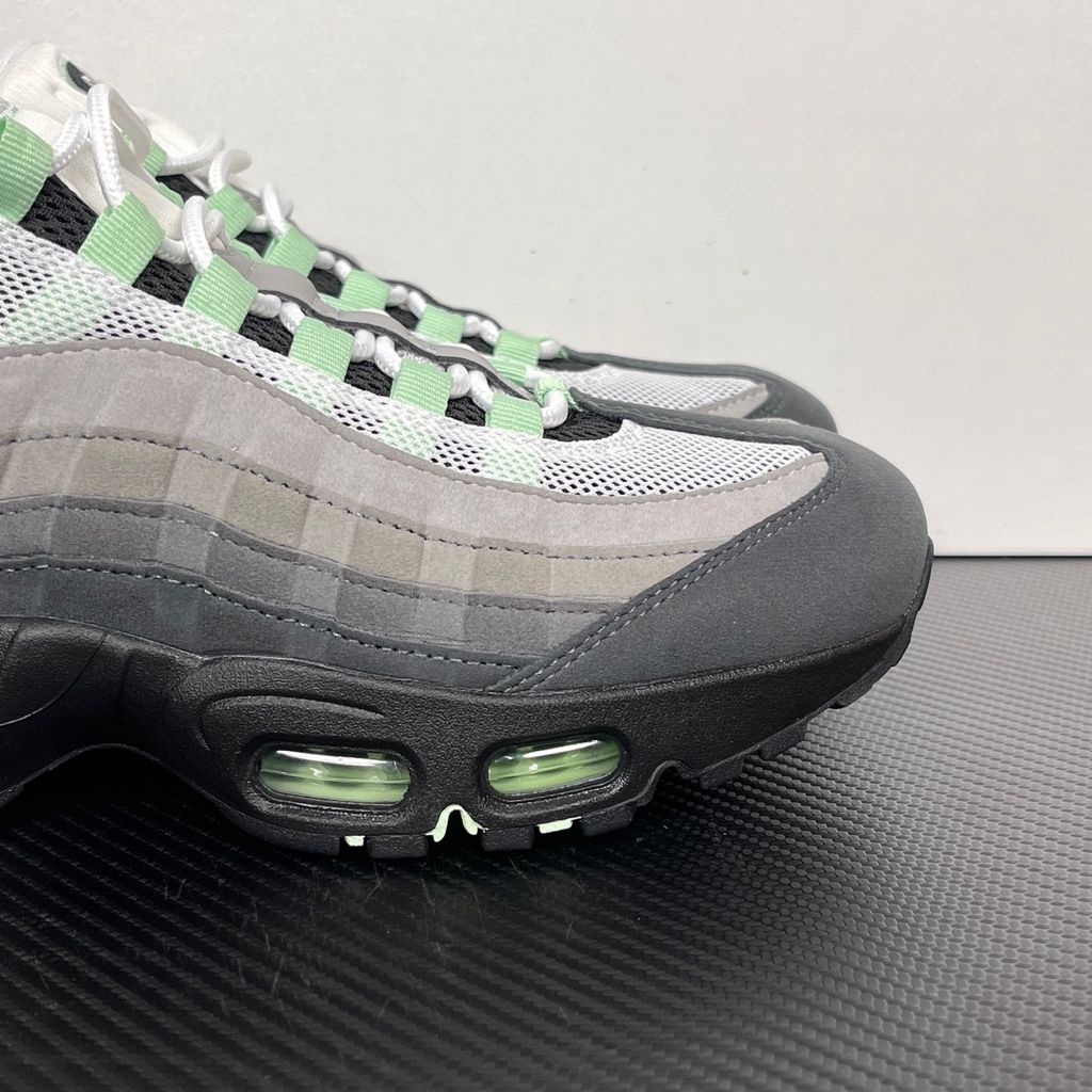 Side profile of the women's Nike Air Max 95 OG 'Big Bubble' Fresh Mint, showcasing the classic grey gradient anatomy-inspired upper, vibrant mint green lace loops and Swoosh, and the exaggerated visible Air units housed within a black midsole.