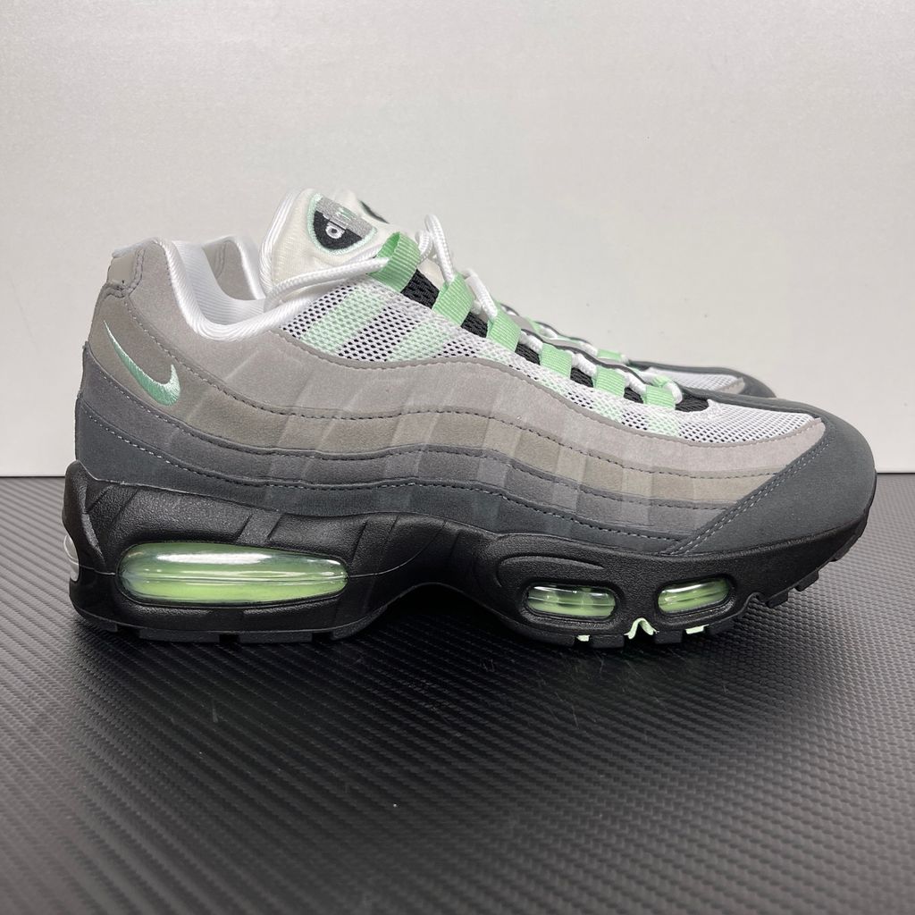 Side profile of the women's Nike Air Max 95 OG 'Big Bubble' Fresh Mint, showcasing the classic grey gradient anatomy-inspired upper, vibrant mint green lace loops and Swoosh, and the exaggerated visible Air units housed within a black midsole.