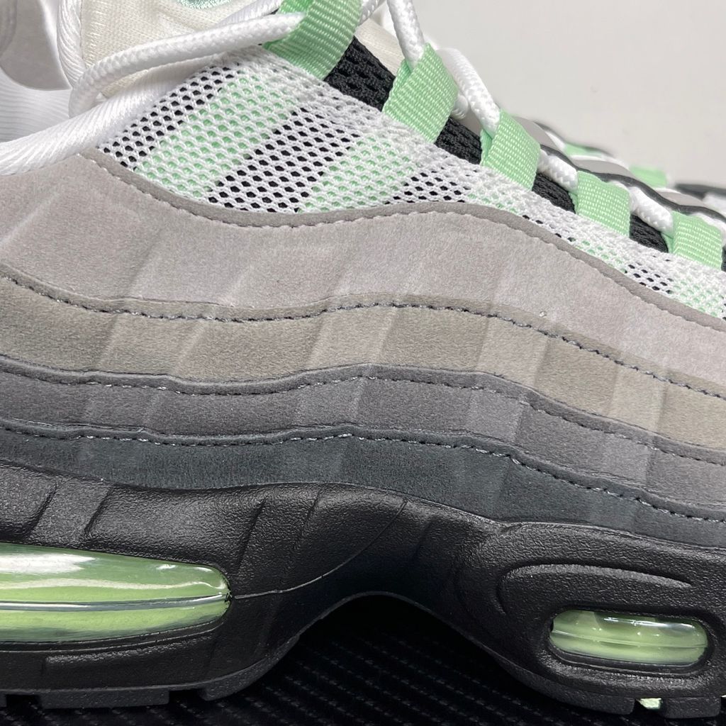 Side profile of the women's Nike Air Max 95 OG 'Big Bubble' Fresh Mint, showcasing the classic grey gradient anatomy-inspired upper, vibrant mint green lace loops and Swoosh, and the exaggerated visible Air units housed within a black midsole.