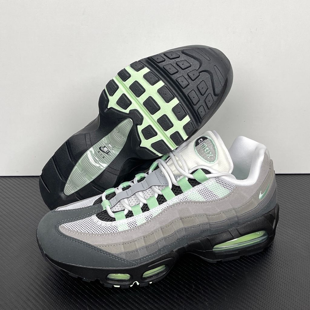 Side profile of the women's Nike Air Max 95 OG 'Big Bubble' Fresh Mint, showcasing the classic grey gradient anatomy-inspired upper, vibrant mint green lace loops and Swoosh, and the exaggerated visible Air units housed within a black midsole.