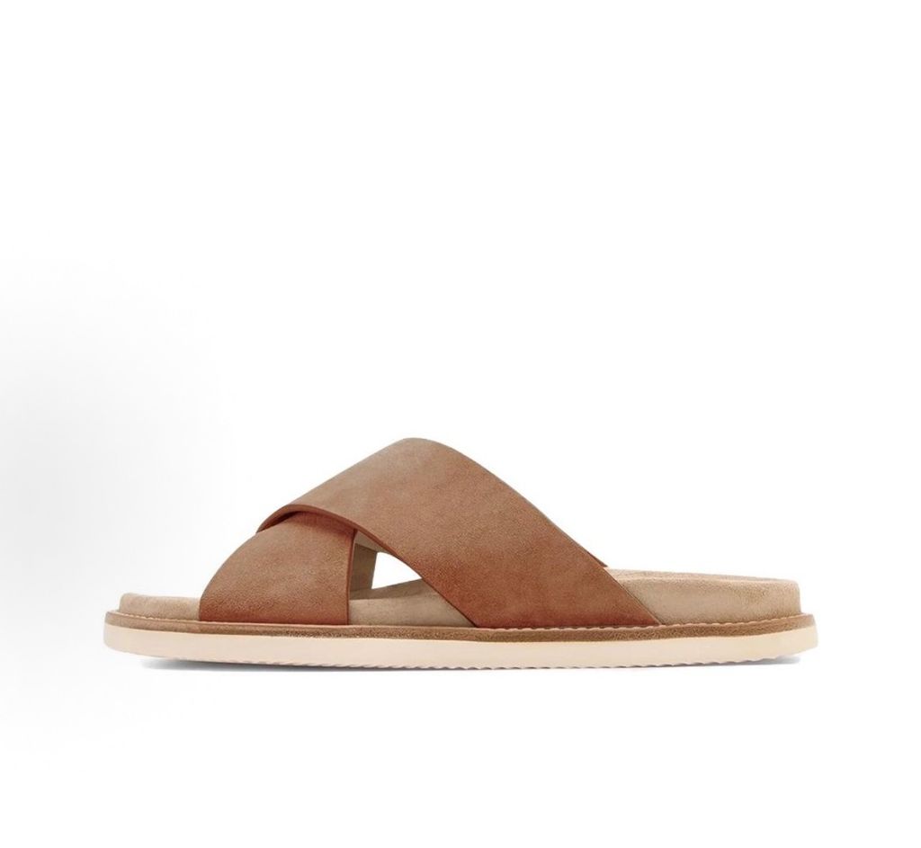 Top-down view of the Brunello Cucinelli suede sandals, showcasing the criss-cross bronze brown straps, soft beige footbed with official stamped branding, and meticulous Italian welt stitching.
