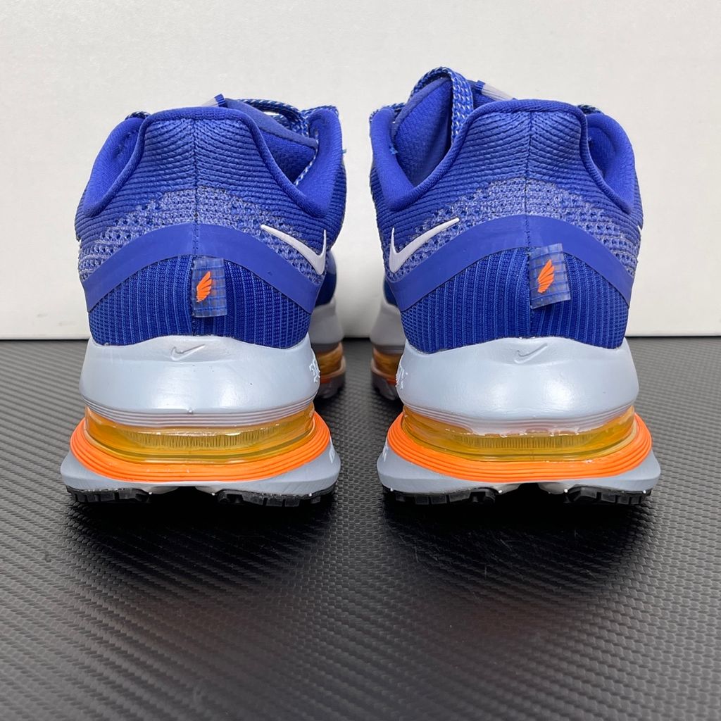 Side profile of the Nike Air Zoom Pegasus Premium, showcasing the vibrant Lapis blue engineered mesh upper, crisp white Nike Swoosh, energetic Total Orange accents, and the groundbreaking sculpted visible Zoom Air unit running through the midsole.