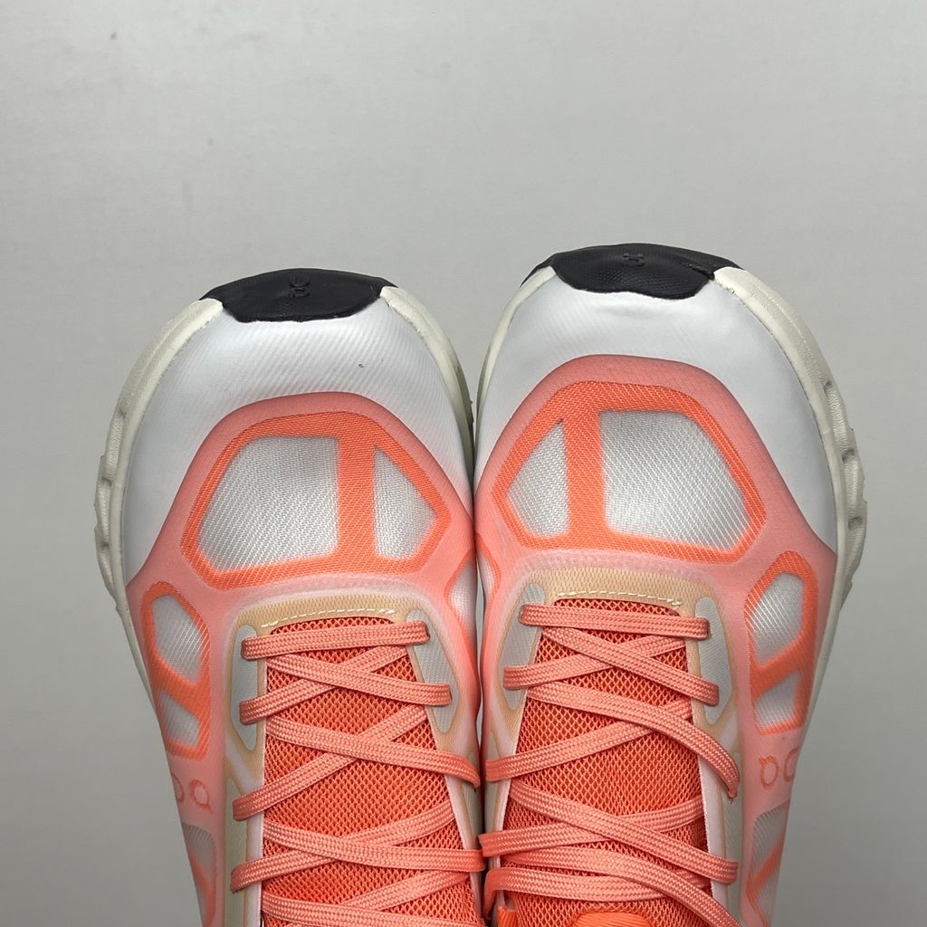 Side profile of the On Running Cloudtilt Remix sneaker, showcasing the vibrant warm orange 'Sunstone' mixed-material upper, quick-adjust speed lacing, and the crisp Ivory white CloudTec Phase® collapsing midsole.