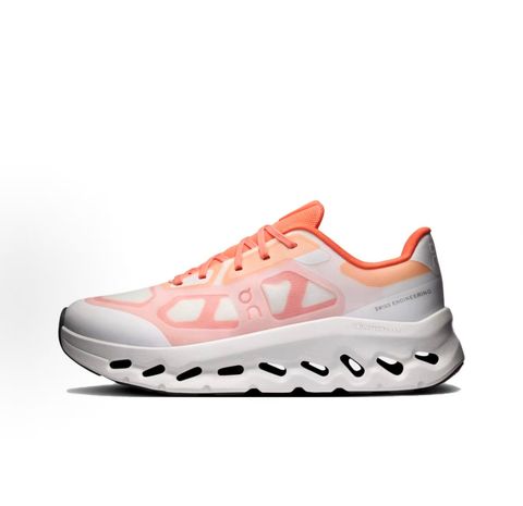 Side profile of the On Running Cloudtilt Remix sneaker, showcasing the vibrant warm orange 'Sunstone' mixed-material upper, quick-adjust speed lacing, and the crisp Ivory white CloudTec Phase® collapsing midsole.