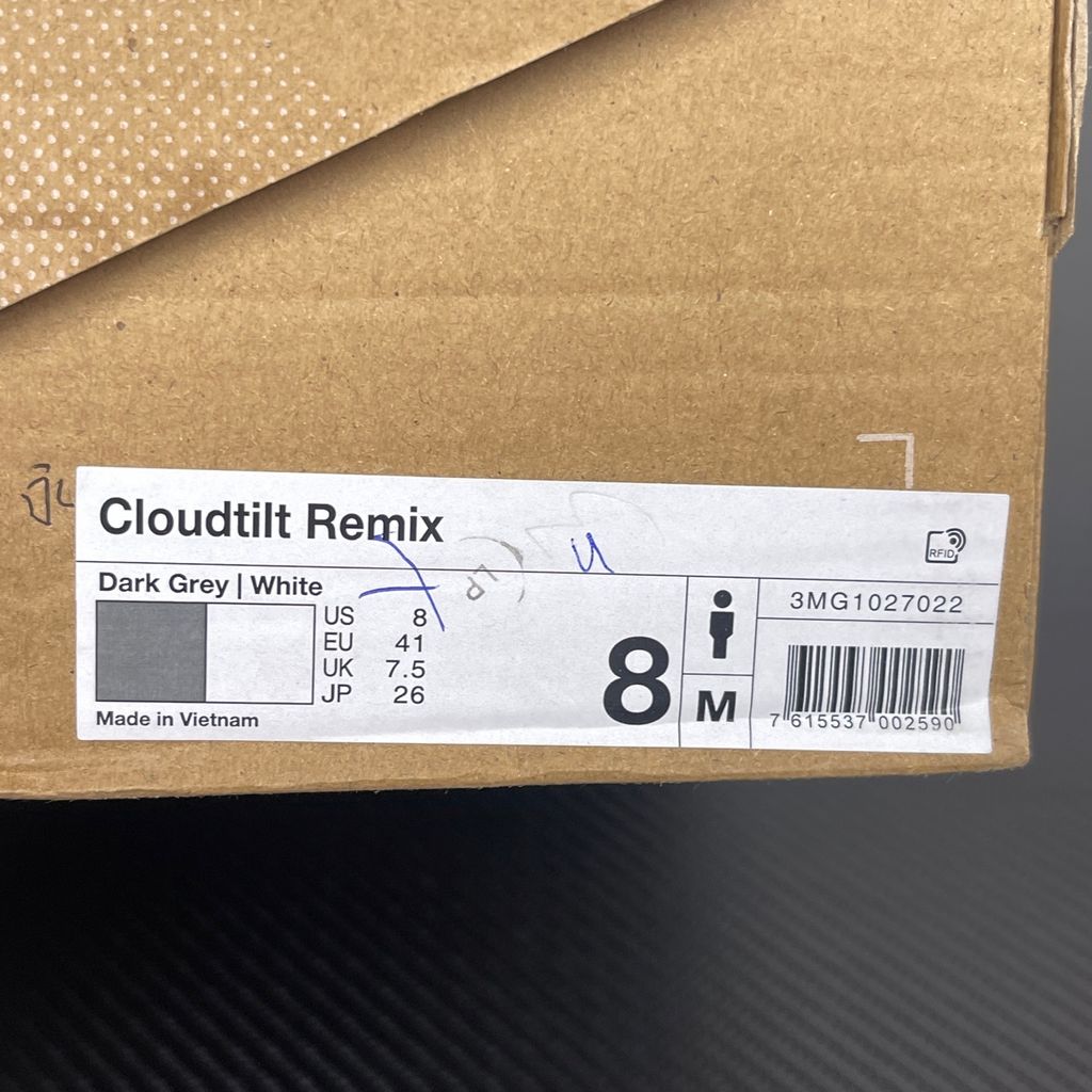 Side profile of the On Running Cloudtilt Remix sneaker, showcasing the mixed-material upper in dark grey and white with subtle green mesh undertones, quick-adjust speed lacing, and the distinctive dark grey CloudTec Phase® collapsing midsole.