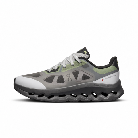 Side profile of the On Running Cloudtilt Remix sneaker, showcasing the mixed-material upper in dark grey and white with subtle green mesh undertones, quick-adjust speed lacing, and the distinctive dark grey CloudTec Phase® collapsing midsole.