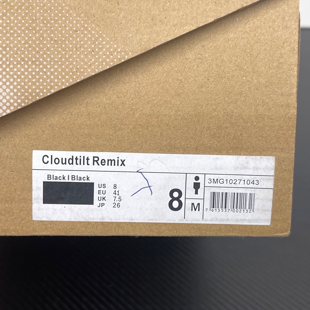 Side profile of the On Running Cloudtilt Remix sneaker in a monochromatic 'Triple Black' colorway, showcasing the mixed-material mesh and synthetic upper, quick-adjust speed lacing, and the stealthy black CloudTec Phase® collapsing midsole.