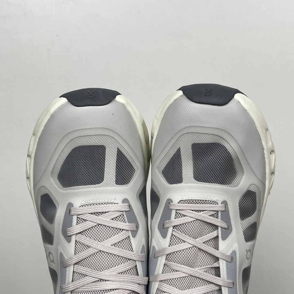 ide profile of the On Running Cloudtilt Remix sneaker, showcasing the mixed-material upper featuring a tonal grey breathable mesh base with matching grey synthetic overlays, speed lacing, and the distinctive white CloudTec Phase® collapsing midsole.