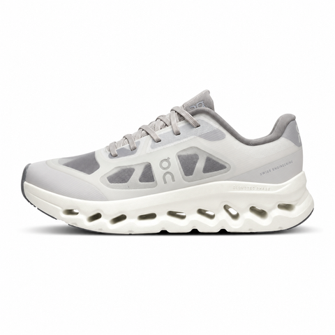 ide profile of the On Running Cloudtilt Remix sneaker, showcasing the mixed-material upper featuring a tonal grey breathable mesh base with matching grey synthetic overlays, speed lacing, and the distinctive white CloudTec Phase® collapsing midsole.