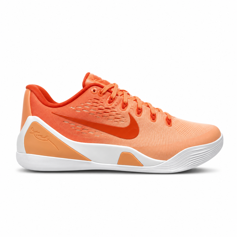 Side profile of the Nike Kobe 9 EM Low Protro, showcasing the vibrant orange Engineered Mesh upper, black Nike Swoosh, carbon fiber heel counter, and the signature pressure-mapped traction pattern on the outsole.