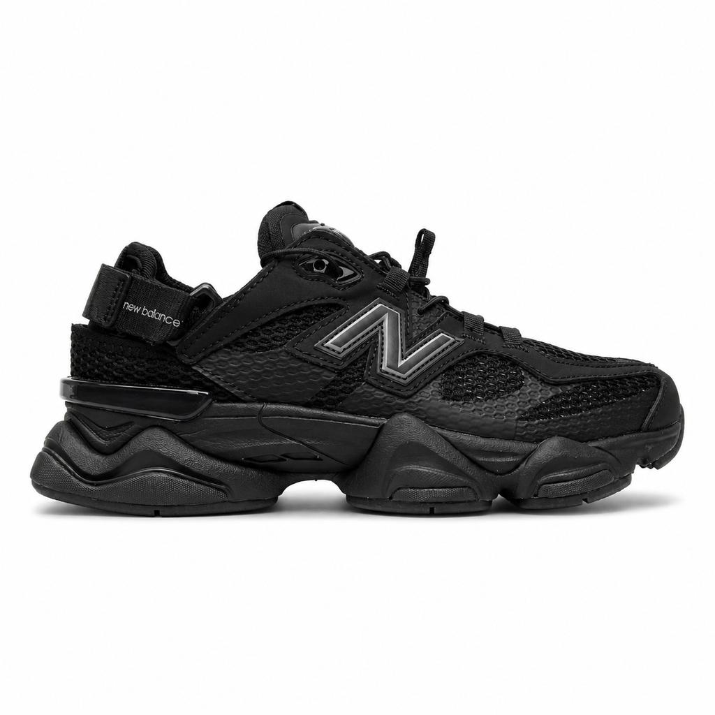 Side profile of the New Balance 9060 sneaker in the 'Summer Black' colorway, showcasing the retro-futuristic chunky midsole, black breathable mesh upper with tonal suede overlays, and the signature metallic 'N' logo on the side panel.