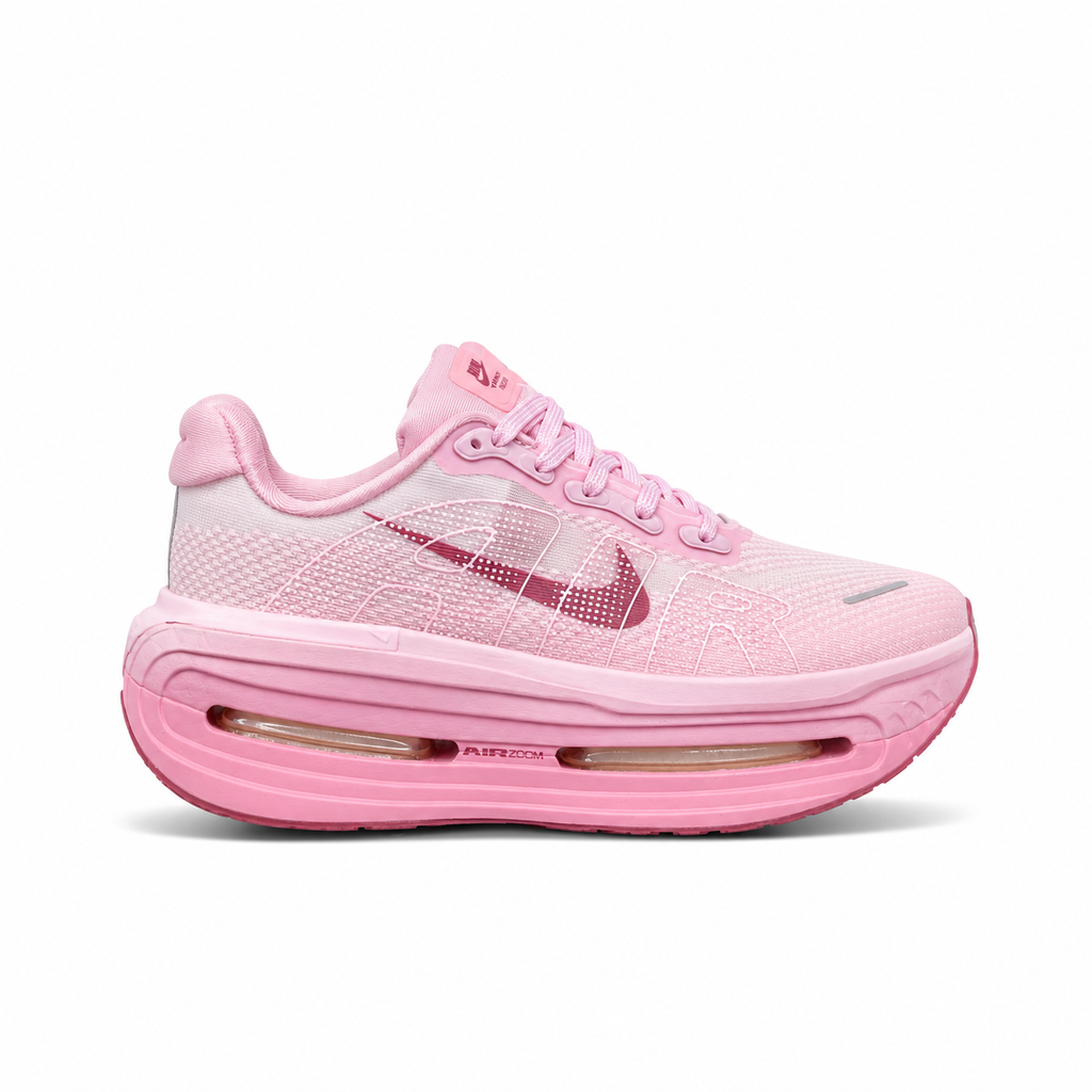 Side profile of the Nike Vomero Premium sneaker in the 'Pink Foam Light Magenta' colorway, showcasing the heavily layered breathable mesh upper, vibrant pink synthetic overlays, the iconic plastic midfoot cage, and the sculpted Cushlon midsole.
