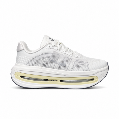 Side profile of the Nike Vomero Premium sneaker in the clean 'Chalk' colorway, showcasing the heavily layered breathable mesh upper, tonal off-white synthetic overlays, the iconic plastic midfoot cage, and the sculpted Cushlon midsole.